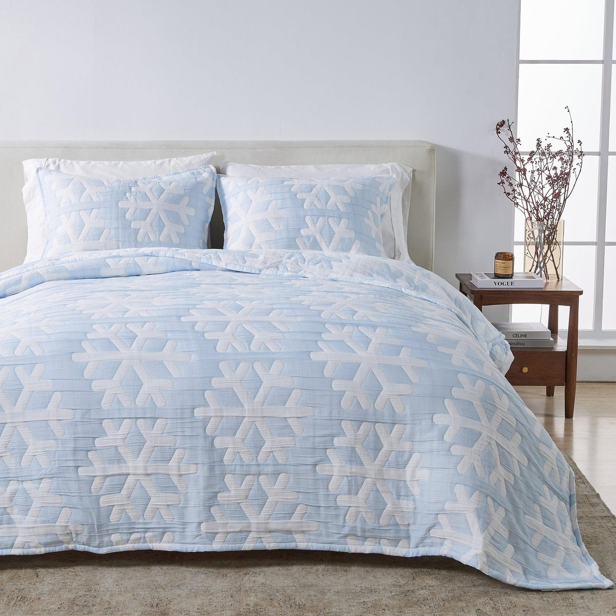 Matelassé Snowflake Quilt Set by Great Bay Home, light blue with white snowflake motif on bed on Tampa Home & Garden Store