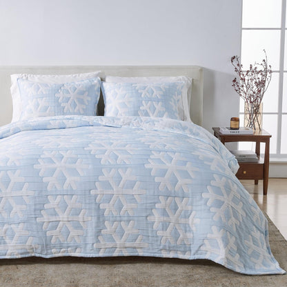 Matelassé Snowflake Quilt Set by Great Bay Home, light blue with white snowflake motif on bed on Tampa Home & Garden Store