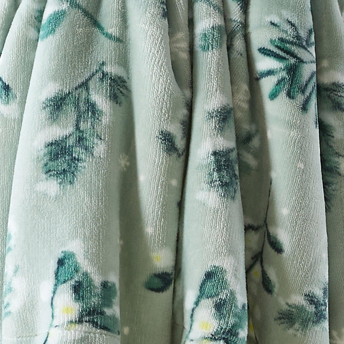 Velvet plush sherpa blanket with teal botanical print on a light background on Tampa Home & Garden Store
