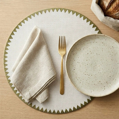 Montana placemat from Talah Home; white dotted placemat with olive-green geometric trim on Tampa Home & Garden Store