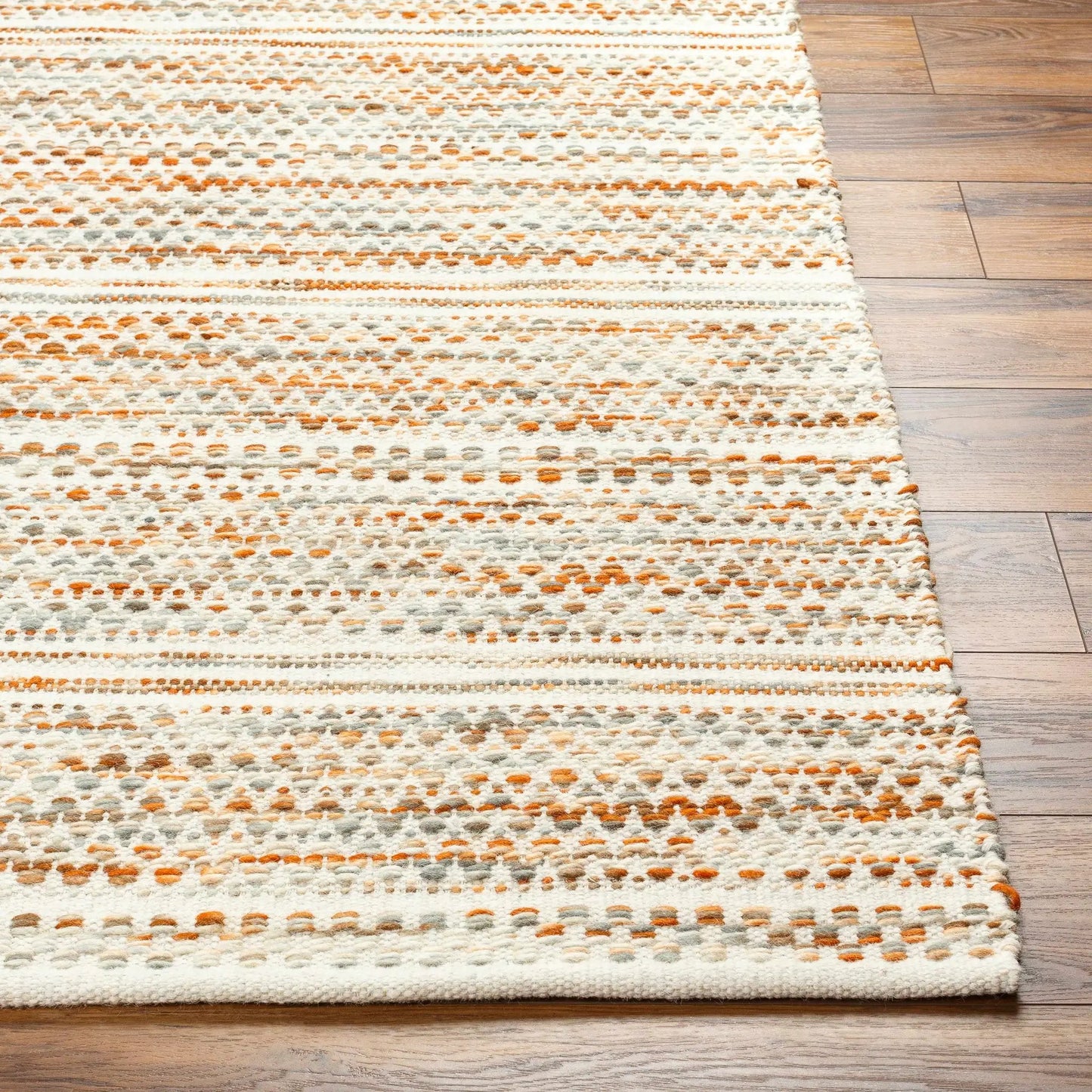 Griet Hand Woven Wool Rug Boutique Rugs white orange gray dotted pattern on wood floor on Tampa Home & Garden Store