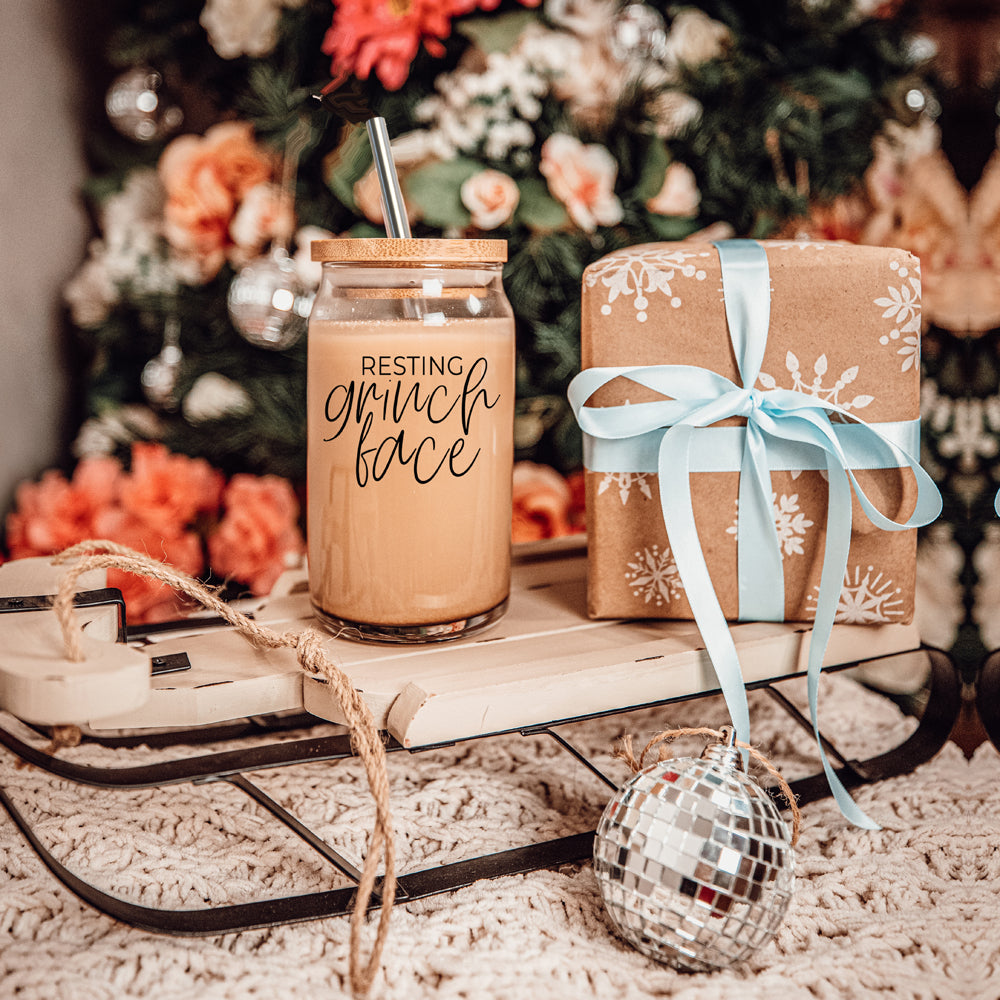 Grinch Face 17oz glass cup set by Gia Roma with cork lid and straw resting grinch face text on Tampa Home & Garden Store