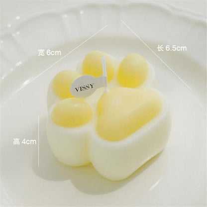 Bear-shaped scented candle in white with yellow paw tips, 6.5×6×4 cm, VISSY tag, Stevvex on Tampa Home & Garden Store