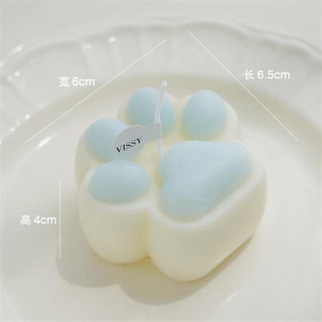 Bear paw candle with blue paw pads on white wax, Stevvex scented cake topper for gift store on Tampa Home & Garden Store