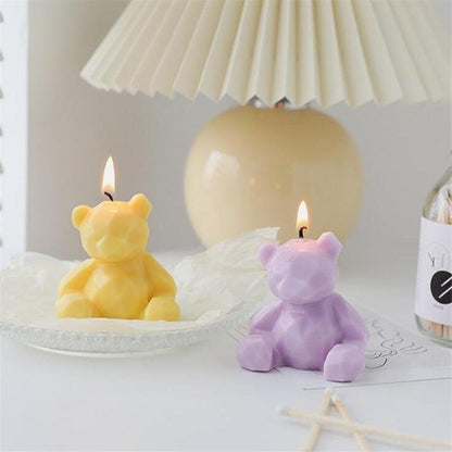 Two bear-shaped scented candles in yellow and lavender with lit wicks, teddy bear decor on Tampa Home & Garden Store