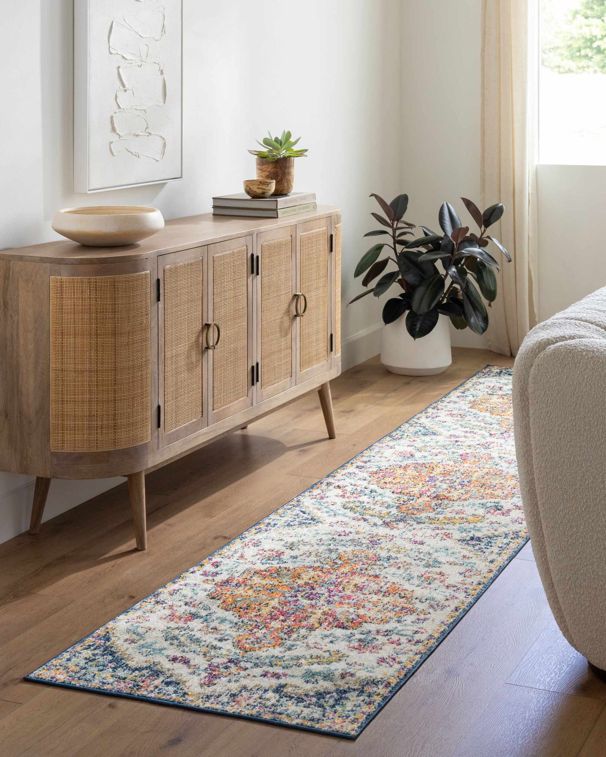 Bodrum Area Rug by Boutique Rugs; multicolor runner with abstract motif beside a wood sideboard on Tampa Home & Garden Store