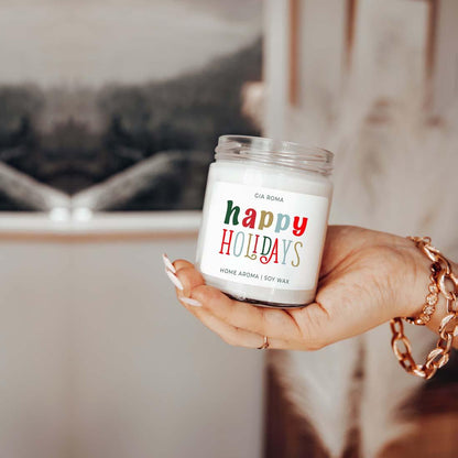 Candle Gia Roma Happy Holidays jar candle with a colorful label and soy wax, held in hand on Tampa Home & Garden Store