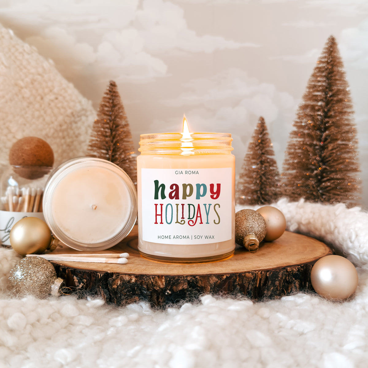 Candle: Gia Roma Happy Holidays soy wax in a cream jar with a bright label, lit on a wood slice on Tampa Home & Garden Store