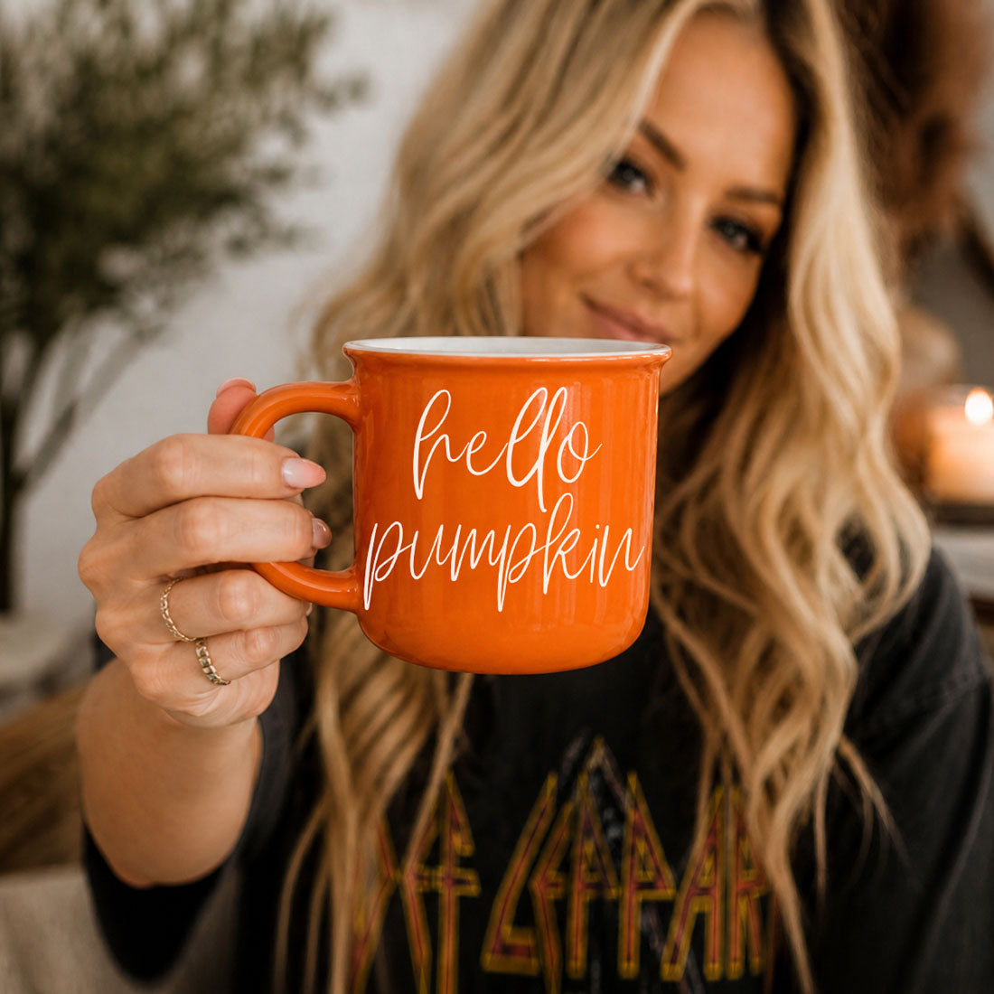Hello Pumpkin coffee mug by Gia Roma, orange ceramic mug held by a woman on Tampa Home & Garden Store