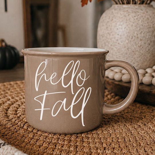 Hello Fall coffee mug taupe ceramic with white cursive hello fall on woven placemat on Tampa Home & Garden Store