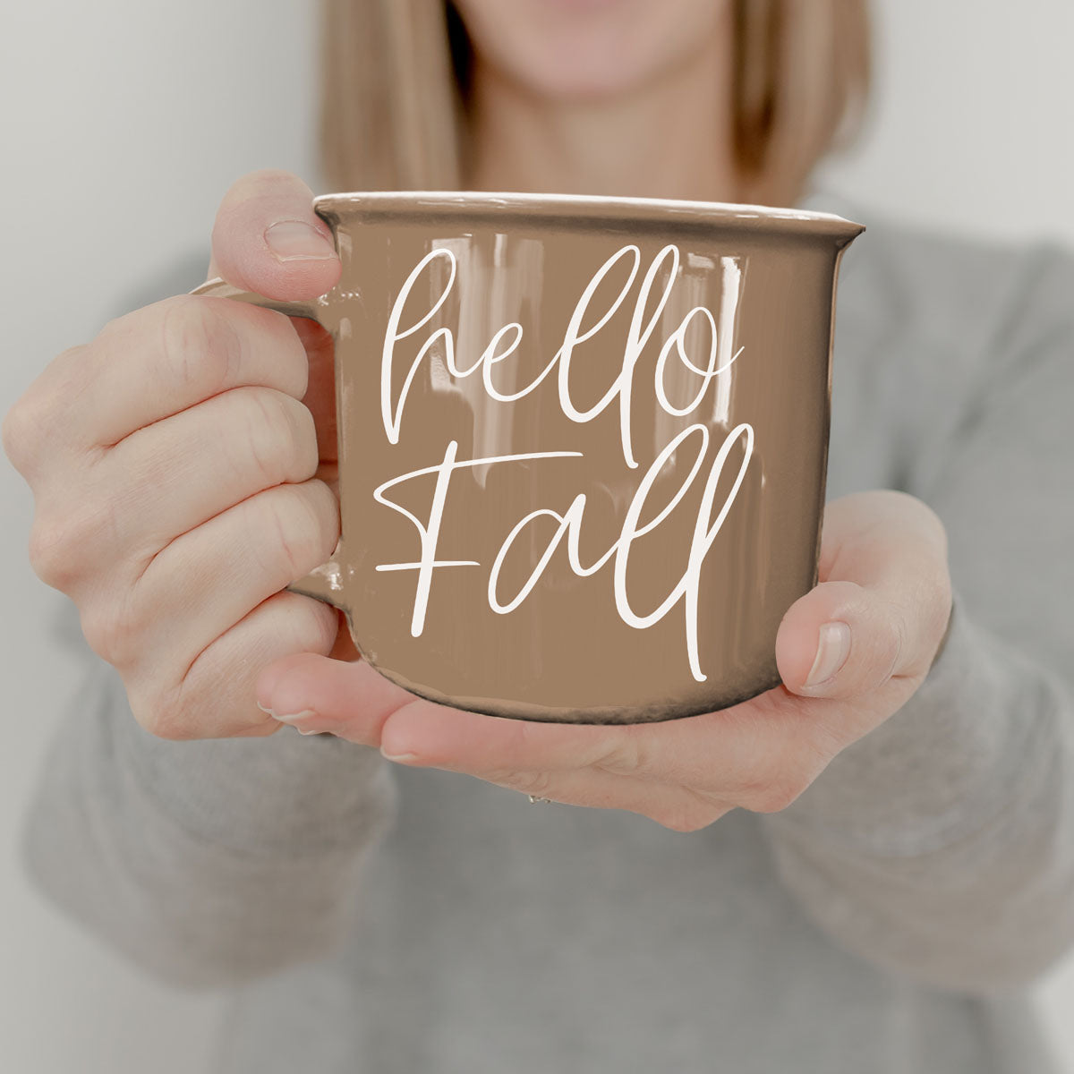 Hello Fall coffee mug by Gia Roma, taupe ceramic with white script held by hands on Tampa Home & Garden Store