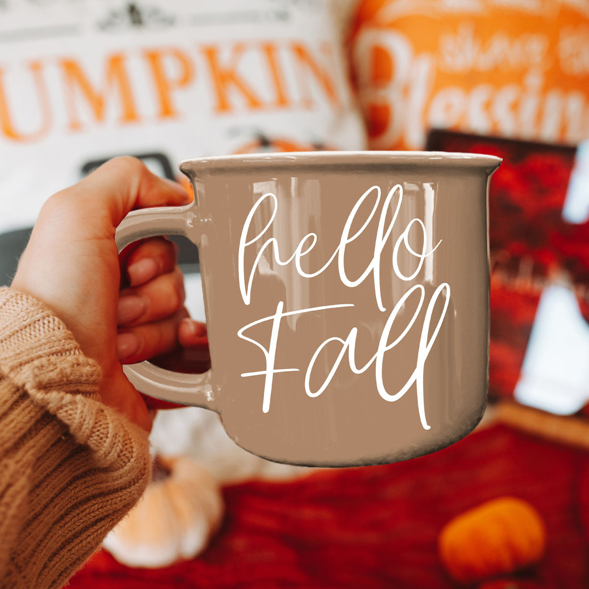 Hello Fall coffee mug in taupe with white script held by hand amid autumn decor on Tampa Home & Garden Store