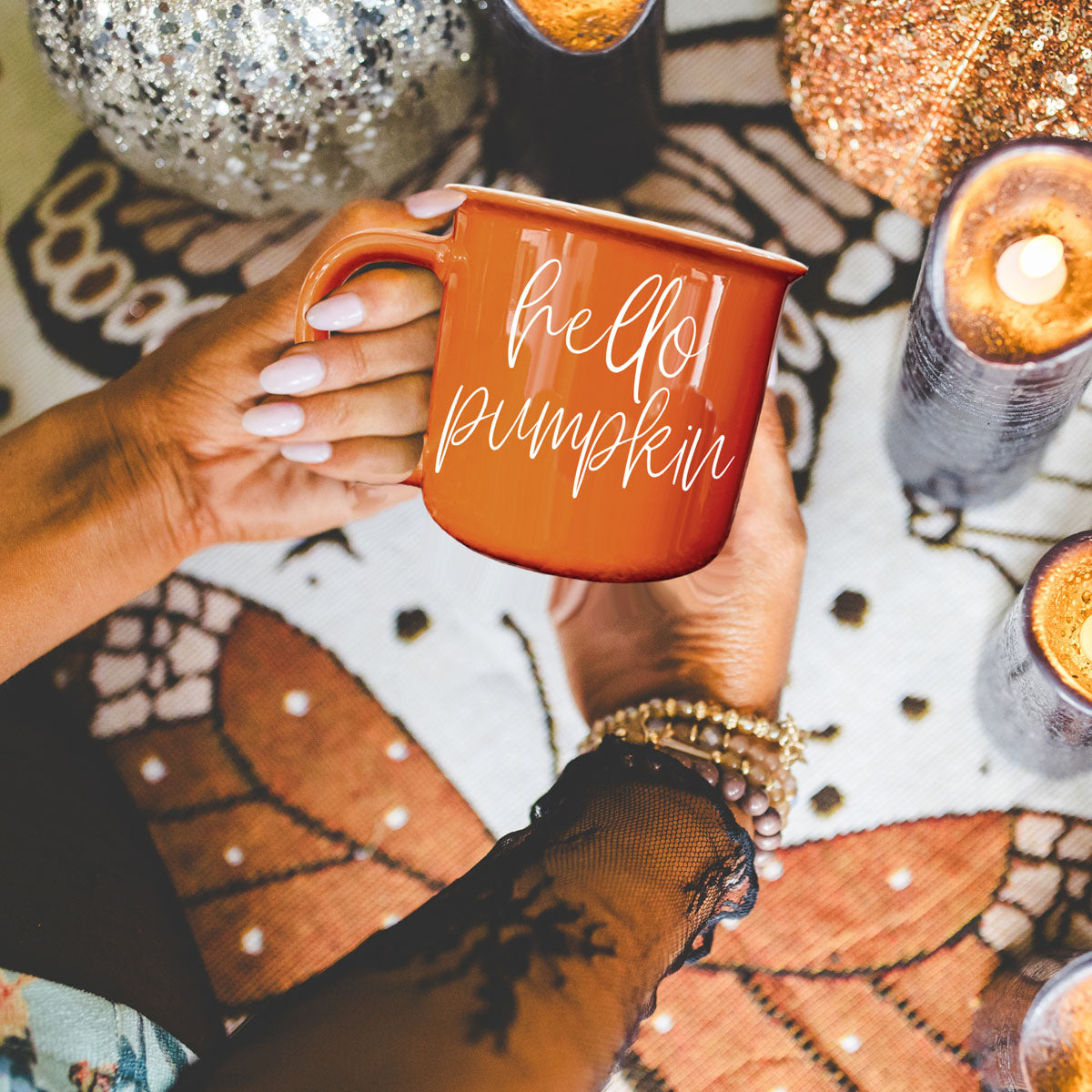 Hello Pumpkin mug by Gia Roma in orange ceramic, held by hands with white nails on Tampa Home & Garden Store