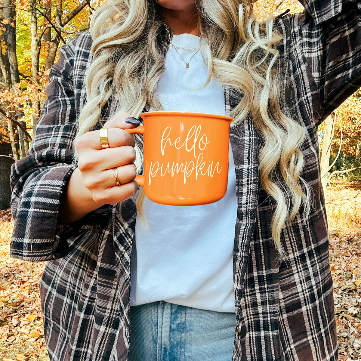 Hello Pumpkin coffee mug, orange ceramic by Gia Roma with white script, held outdoors in fall on Tampa Home & Garden Store