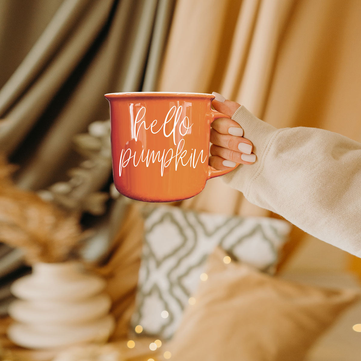 Hello Pumpkin mug by Gia Roma, orange ceramic mug held in a beige-sleeve hand on Tampa Home & Garden Store