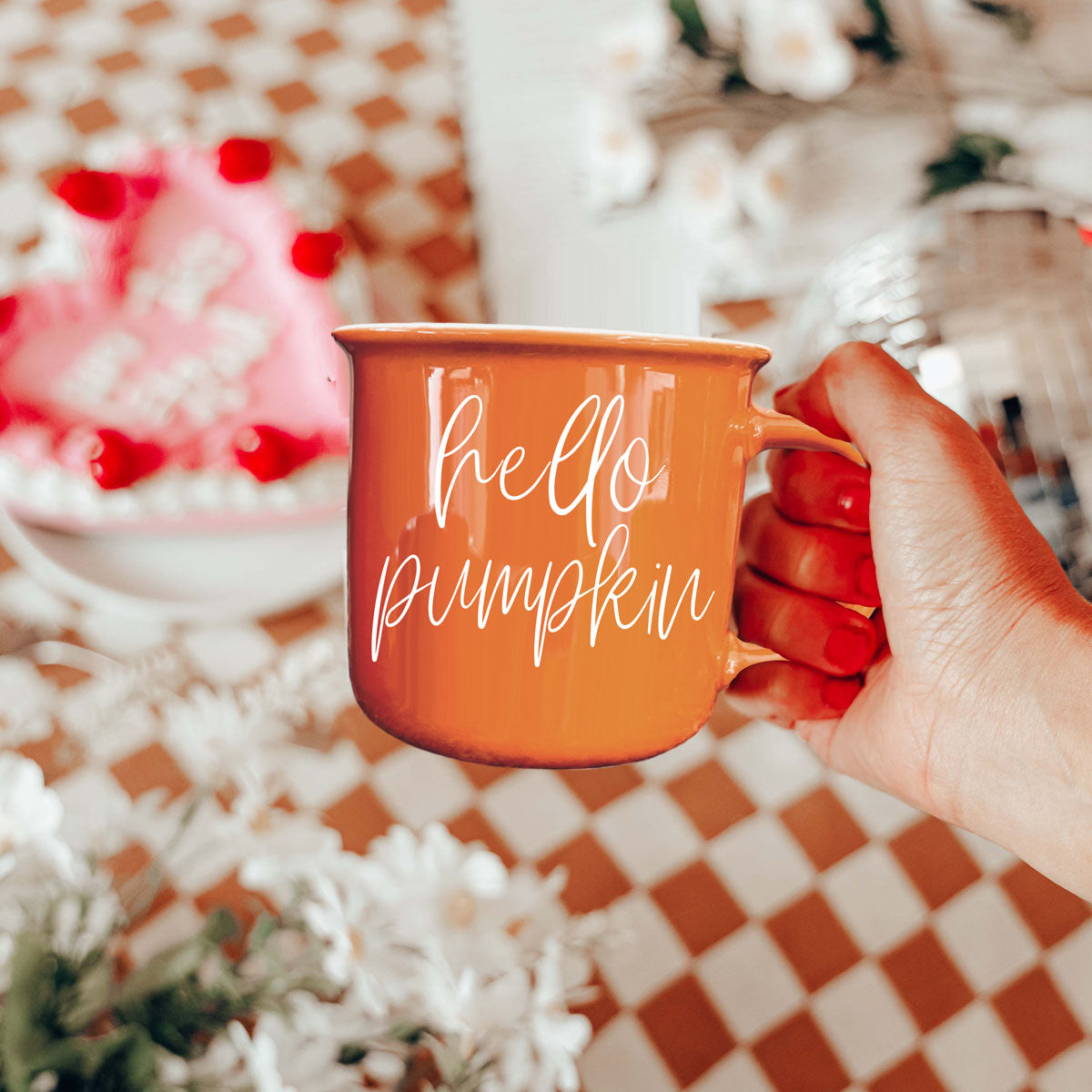 Hello Pumpkin coffee mug by Gia Roma in orange ceramic with white script held in hand on Tampa Home & Garden Store