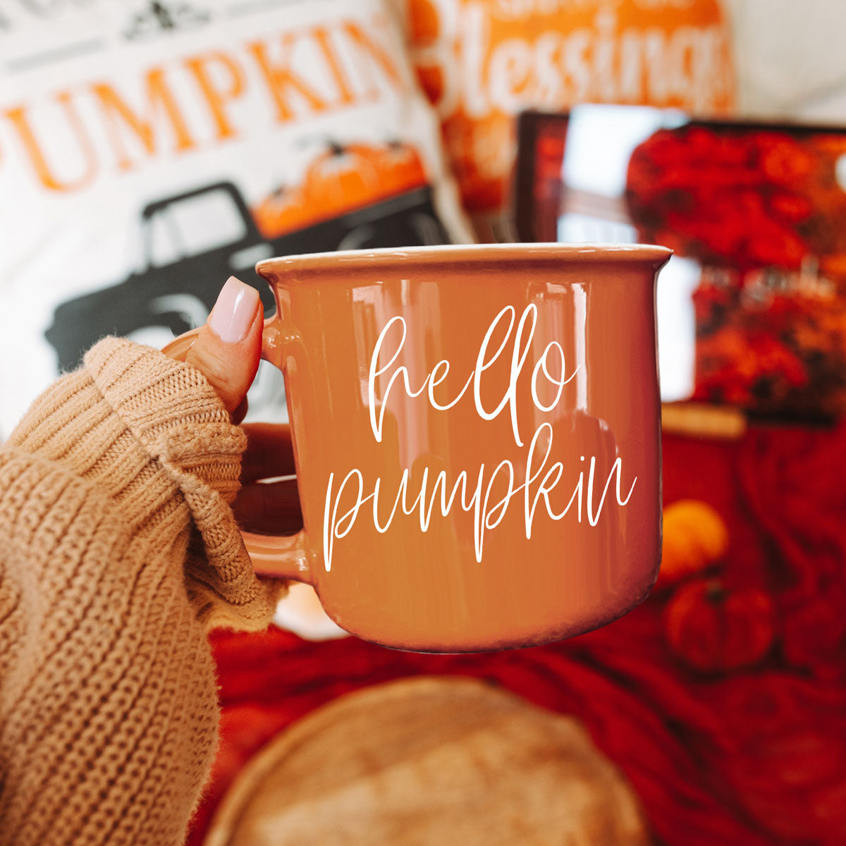 Hello Pumpkin coffee mug by Gia Roma in warm orange ceramic glaze held by a knit-gloved hand on Tampa Home & Garden Store