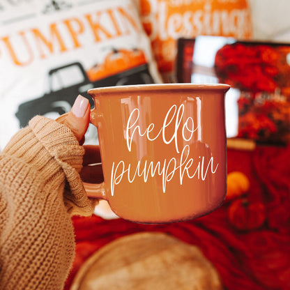 Hello Pumpkin coffee mug by Gia Roma in warm orange ceramic glaze held by a knit-gloved hand on Tampa Home & Garden Store