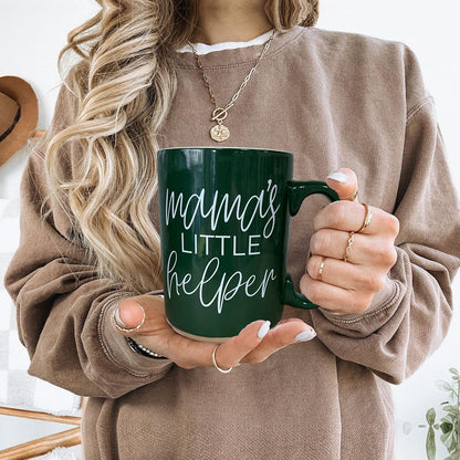 Mama's Little Helper mug, Gia Roma, green ceramic, held by a woman in beige sweater on Tampa Home & Garden Store