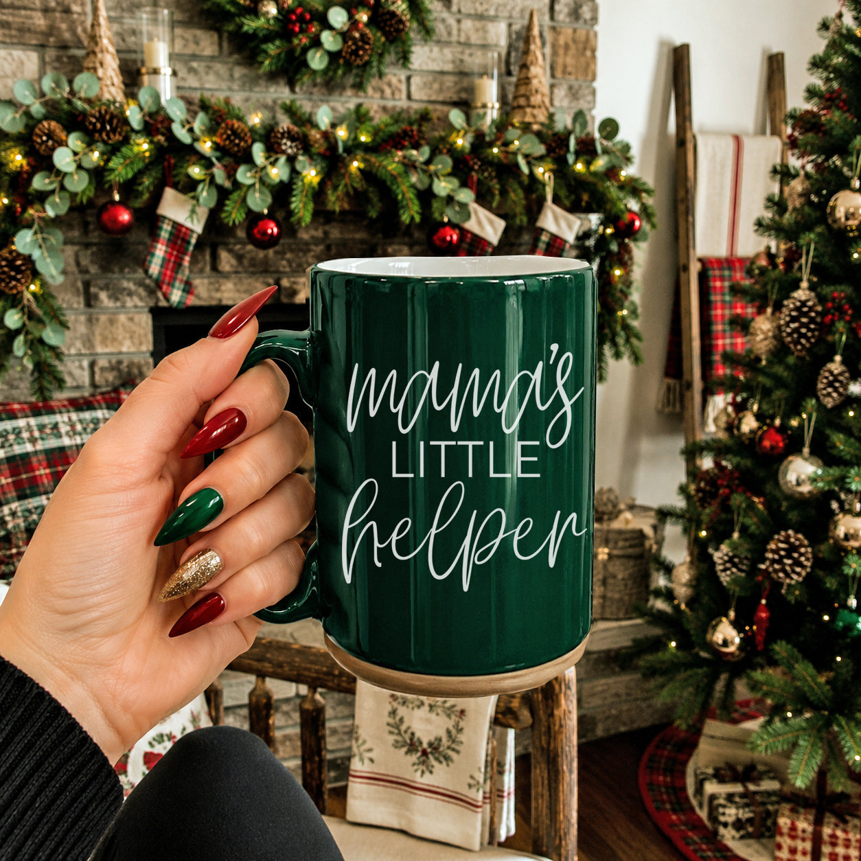 Mama's Little Helper coffee mug in green ceramic with white script, held amid festive decor on Tampa Home & Garden Store
