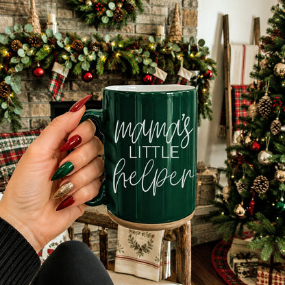 Mama's Little Helper coffee mug in green ceramic with white script, held amid festive decor on Tampa Home & Garden Store