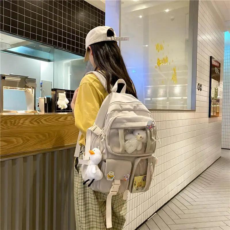 Stevvex nylon large-capacity waterproof school backpack in cream with clear front pocket and plush duck keychain on Tampa Home & Garden Store