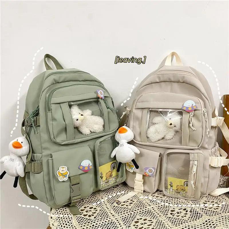 Stevvex nylon waterproof school backpack pair in green and beige with plush keychains on Tampa Home & Garden Store
