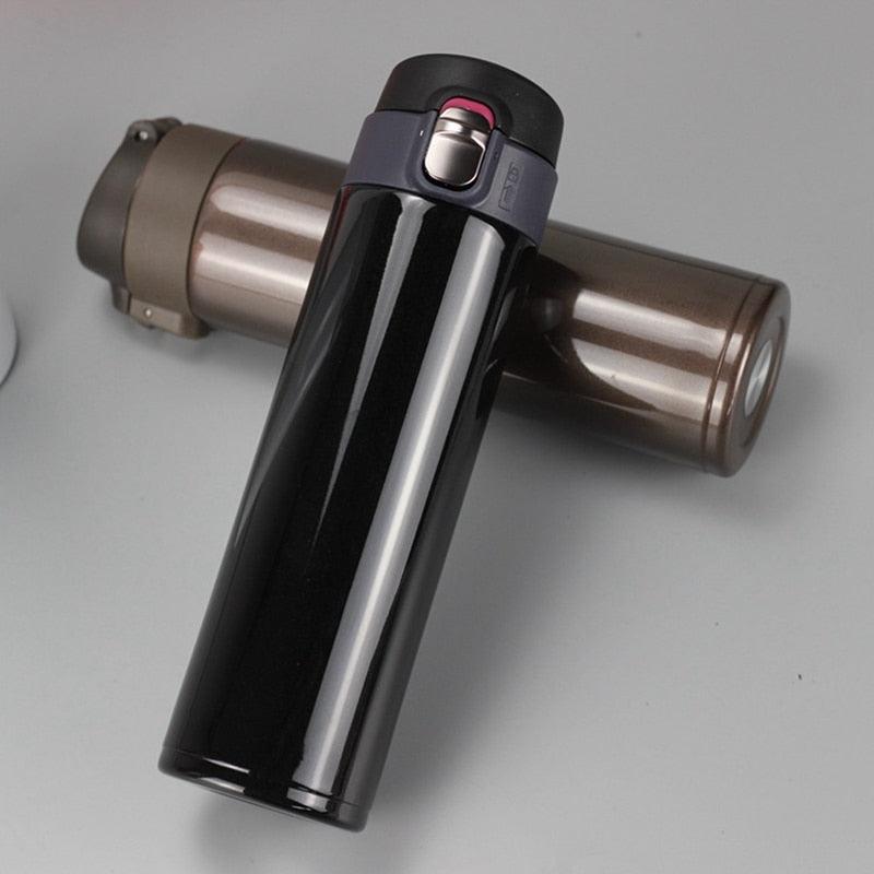 Stevvex black stainless steel thermos bottle with finish, insulated travel mug beside thermos on Tampa Home & Garden Store