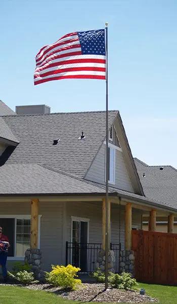 Titan Telescoping Flagpole with American flag on a tall residential flagpole on Tampa Home & Garden Store