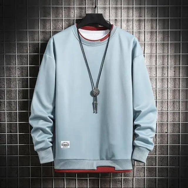 Men's light blue Stevvex sweatshirt on hanger with cuffs and hem, pendant necklace visible on Tampa Home & Garden Store