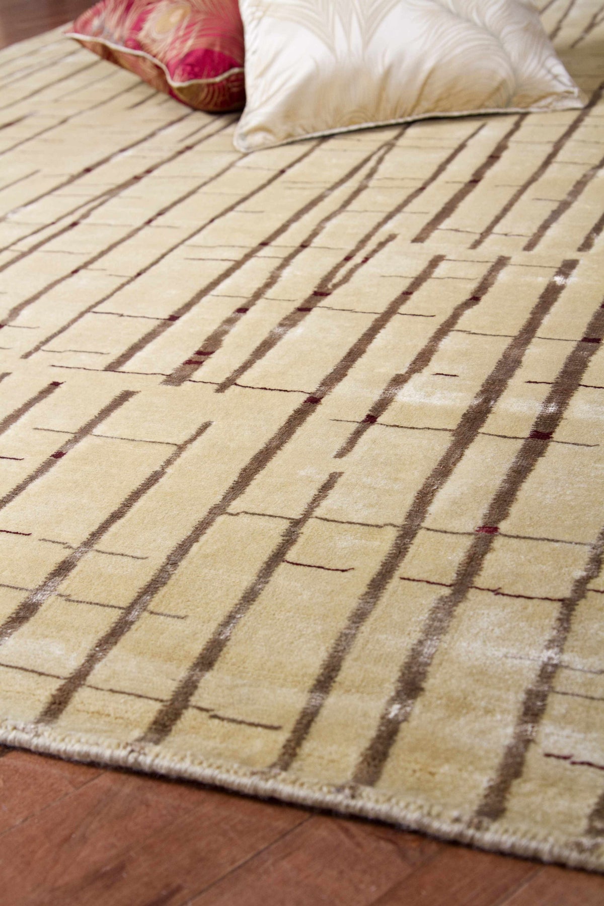 Hotchkiss area rug beige field with brown linear stripe pattern on hardwood floor on Tampa Home & Garden Store
