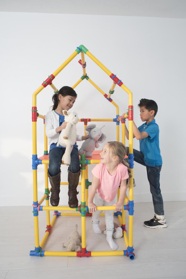 TubeLox Deluxe Set playground frame built from yellow red blue tubes; kids play with stuffed animals on Tampa Home & Garden Store