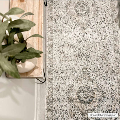 Cara Flat Pile Washable Rug in gray with antique medallion pattern on light floor on Tampa Home & Garden Store