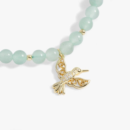 Hummingbird Gemstone Bolo Bracelet with mint green beads and gold-tone hummingbird charm on Tampa Home & Garden Store