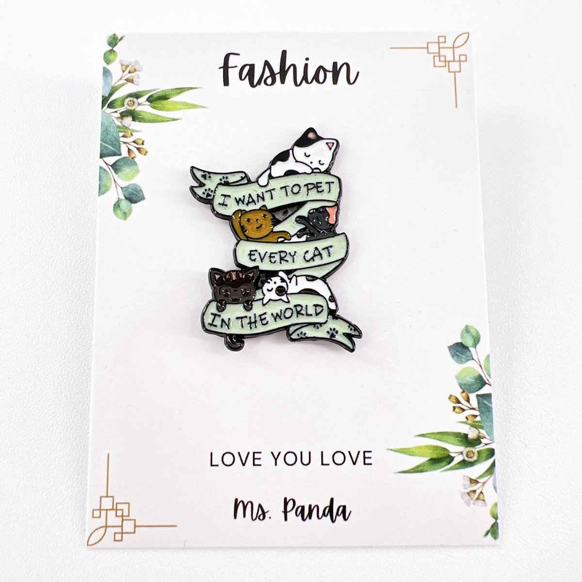 I Want to Pet Every Cat enamel pin featuring stacked cats and pale blue ribbon banners on Tampa Home & Garden Store