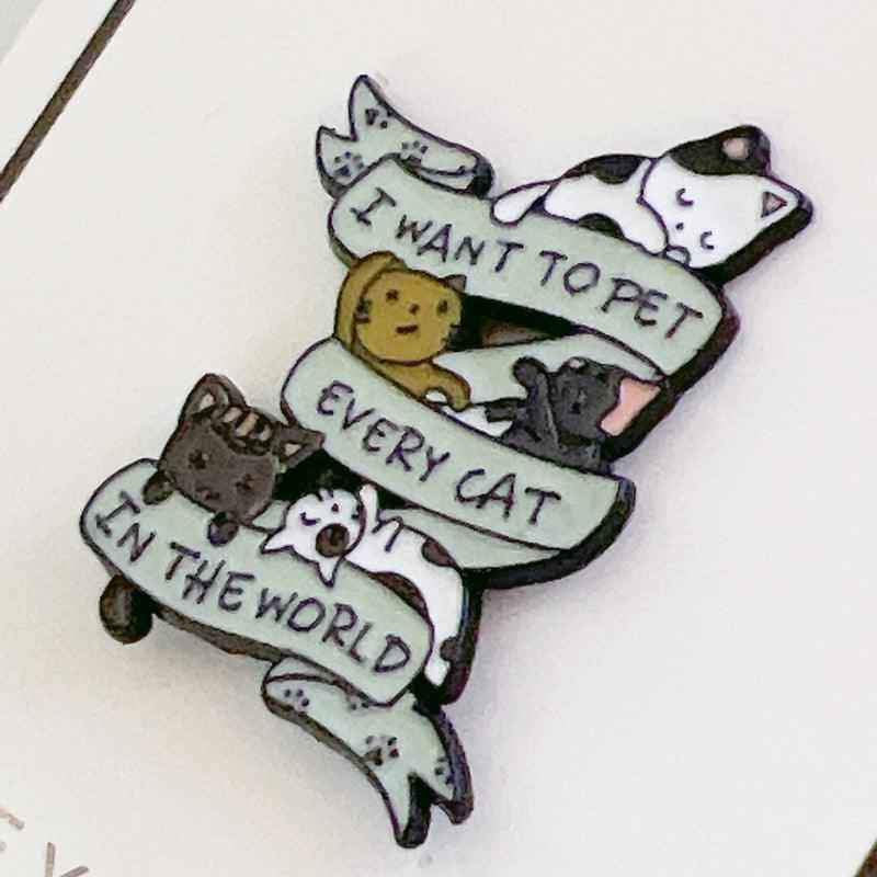 Cat enamel pin by Shaketea with cats and a banner I WANT TO PET EVERY CAT IN THE WORLD on Tampa Home & Garden Store