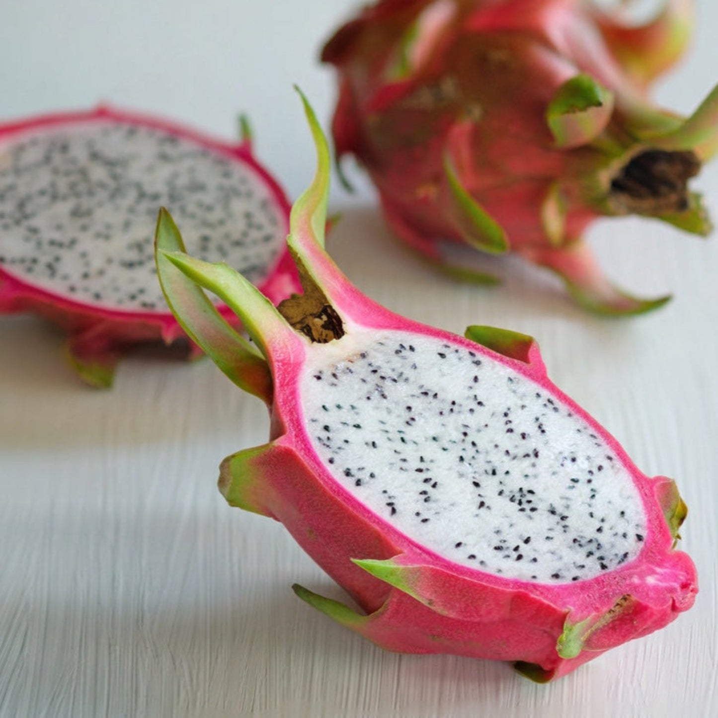 White dragon fruit slices with pink rind and black seeds on Tampa Home & Garden Store