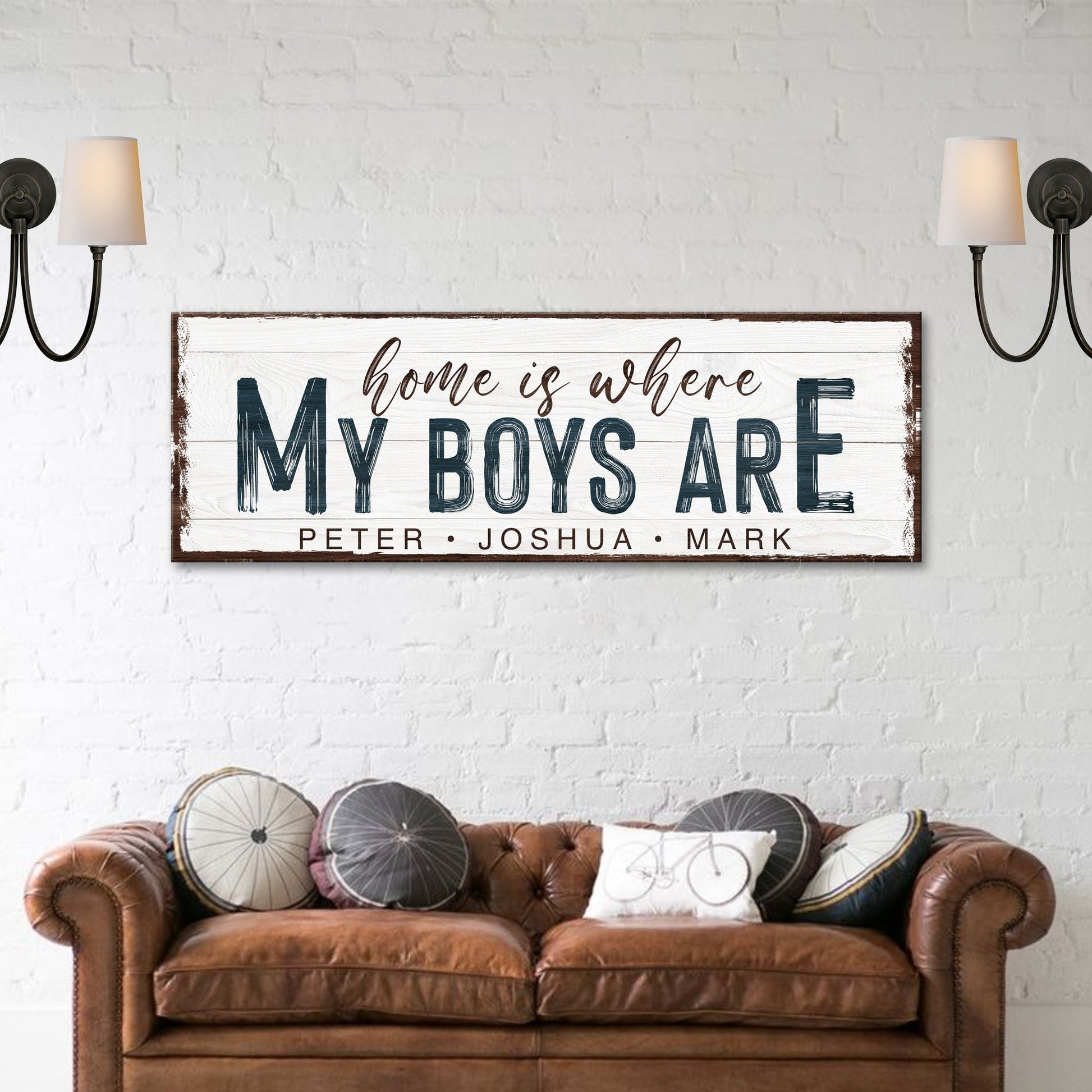 Home Is Where My Boys Are sign canvas with distressed border above brown sofa on Tampa Home & Garden Store