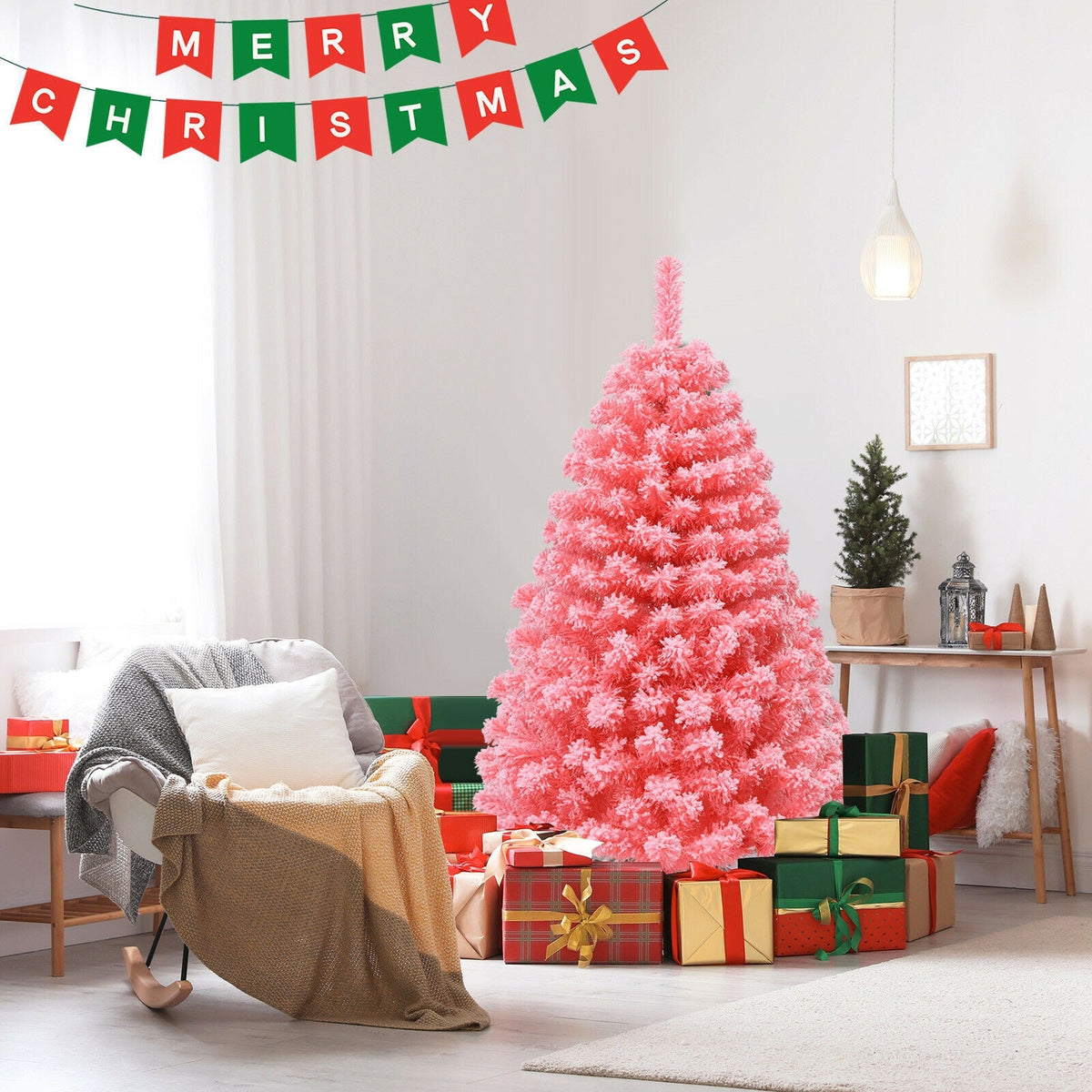 Pink Christmas tree with snow-flocked PVC tips and metal stand in a bright living room on Tampa Home & Garden Store