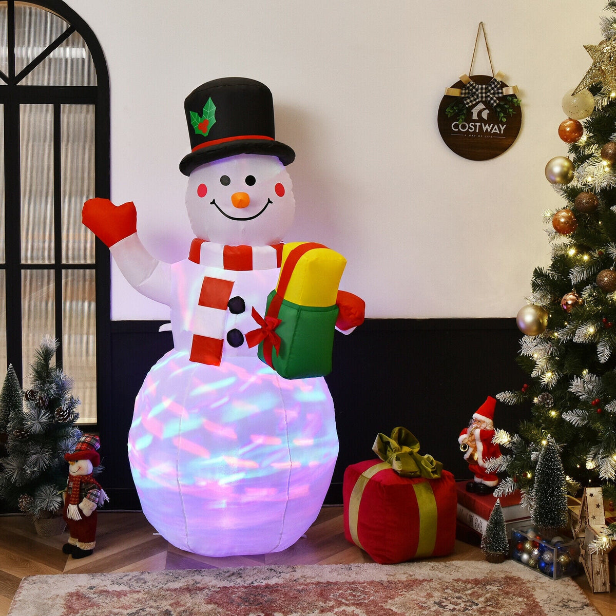 5 ft tall inflatable snowman with LED lights, hat, holly, red scarf and mittens, holding gift on Tampa Home & Garden Store