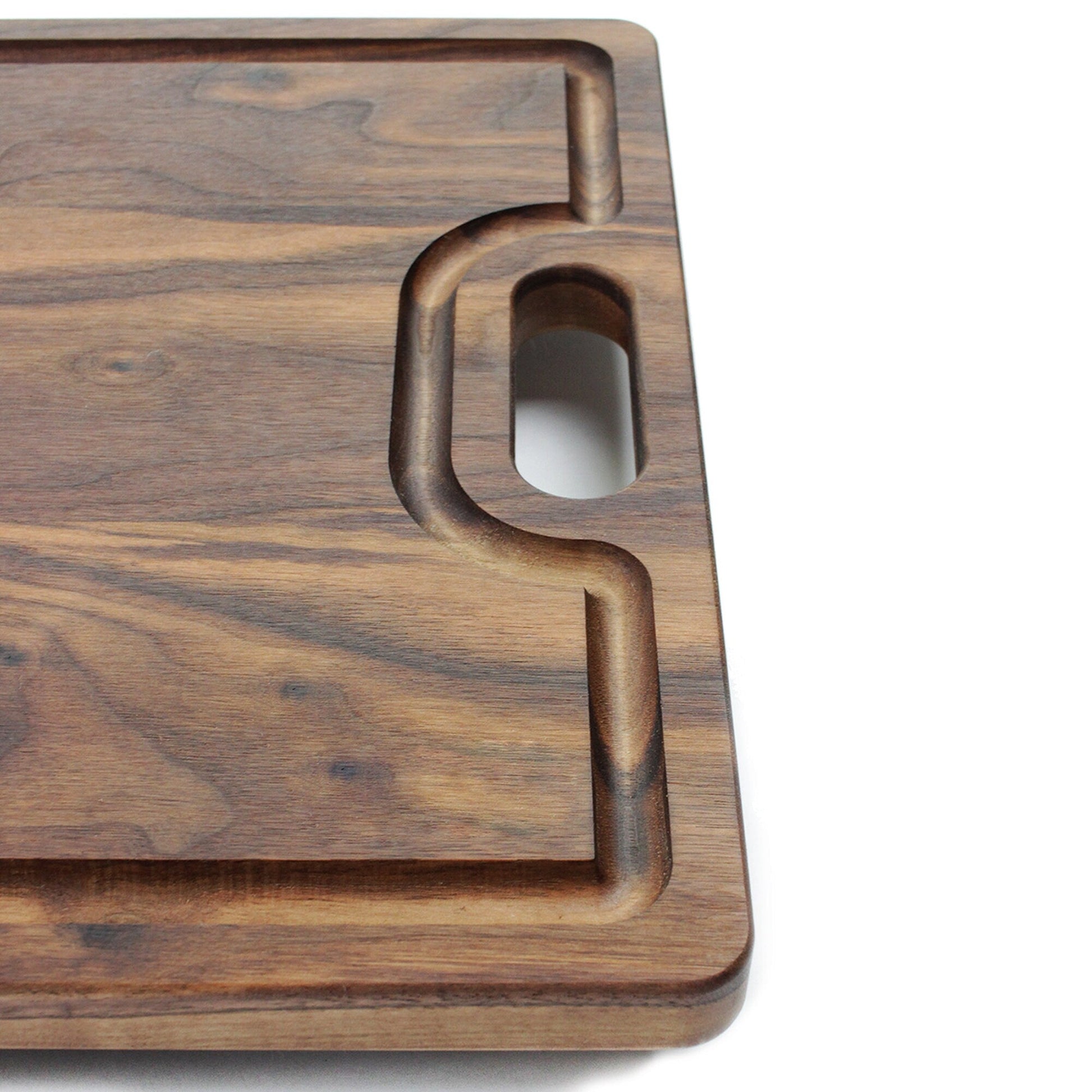 Walnut cutting board with juice groove and integrated handle cutout on Tampa Home & Garden Store