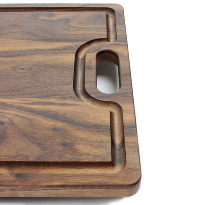 Walnut cutting board with juice groove and integrated handle cutout on Tampa Home & Garden Store