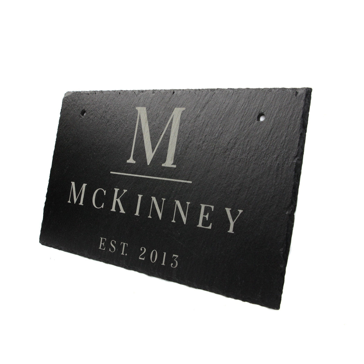 Slate hanging sign with large M monogram and McKinney Est. 2013 text on Tampa Home & Garden Store