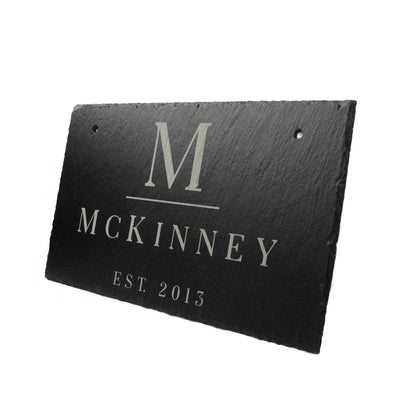 Slate hanging sign with large M monogram and McKinney Est. 2013 text on Tampa Home & Garden Store
