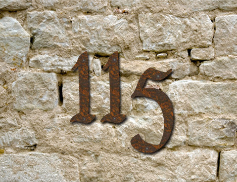 Rustic house numbers 1 and 5 in Pennybridge font, rusty metal finish on a stone wall on Tampa Home & Garden Store