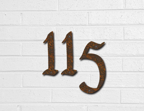 Rustic Pennybridge font house numbers three rusted metal numerals 1 1 5 on white brick wall on Tampa Home & Garden Store
