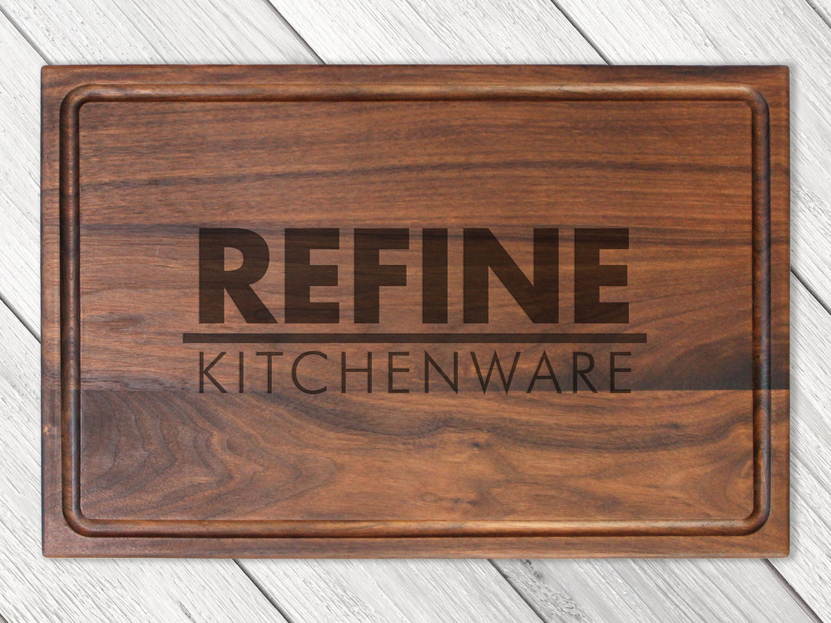 Custom logo cutting board in dark walnut wood with engraved REFINE KITCHENWARE branding on Tampa Home & Garden Store