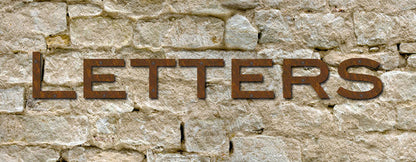 Blair Font rustic metal house numbers letters set of 6 in brown rust finish on stone wall on Tampa Home & Garden Store