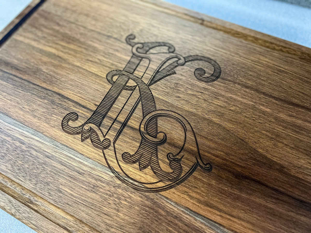 Custom logo cutting board with ornate monogram engraving on wood on Tampa Home & Garden Store