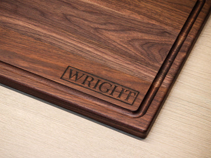Personalized cutting board with custom engraving along edge in dark walnut wood on Tampa Home & Garden Store